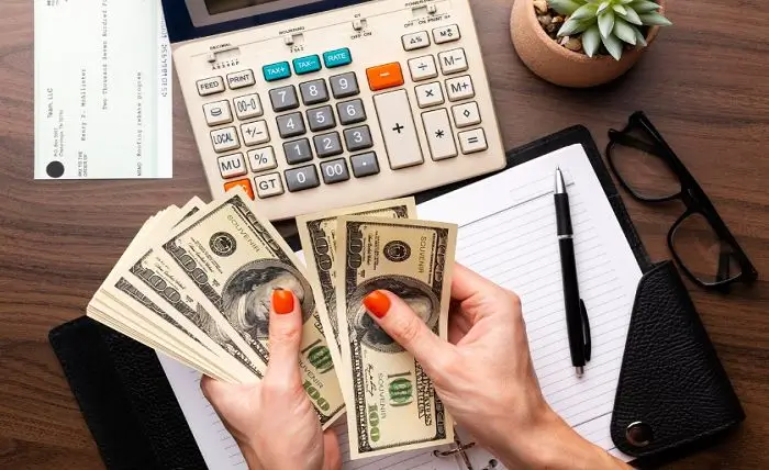 Business owner reviewing budget and expenses with financial advisor in Edinburgh