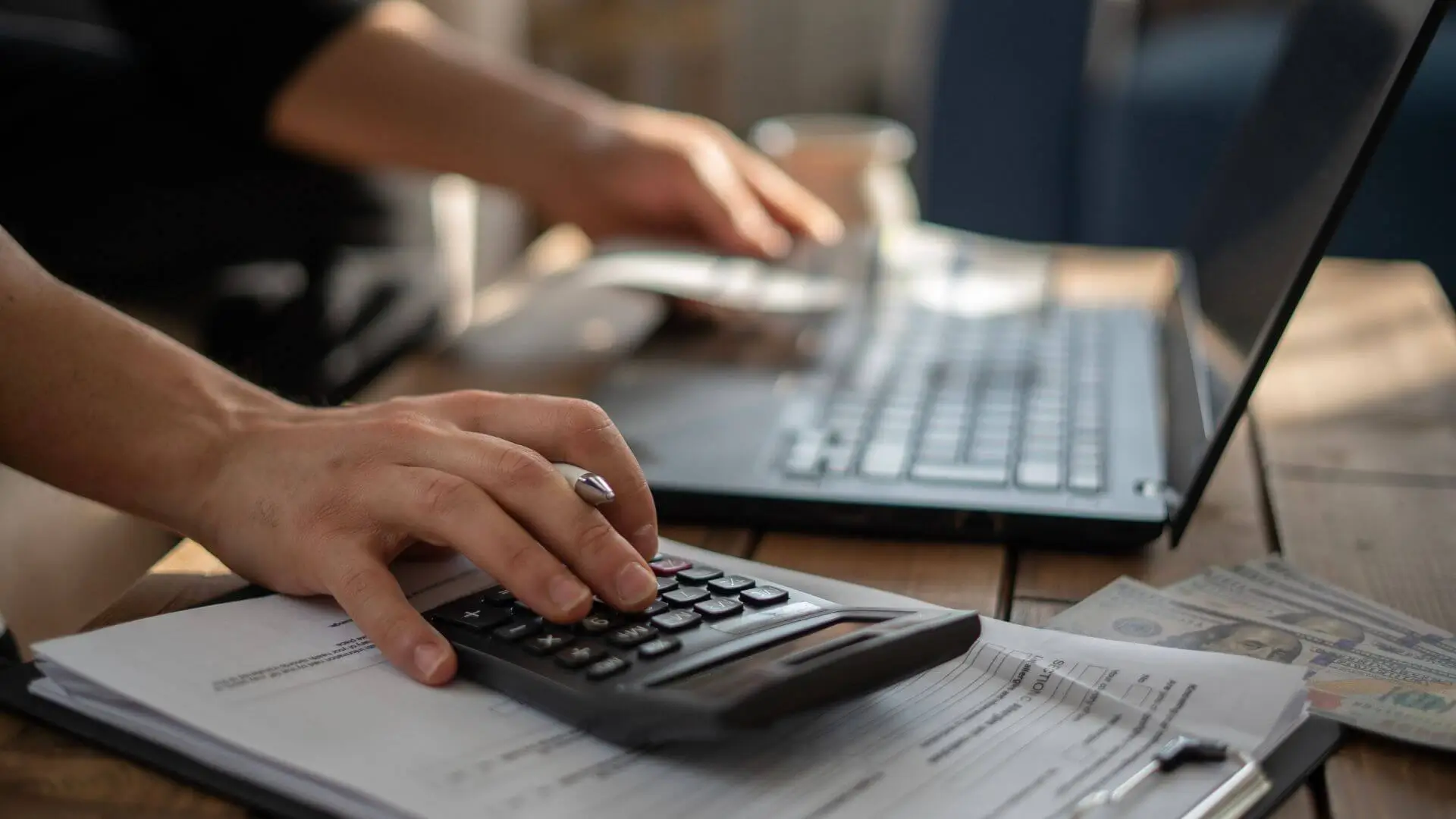 Business owner reviewing budget and expenses with financial advisor in Edinburgh