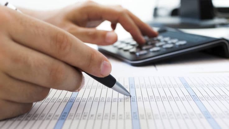 Statutory returns filing service provider at desk preparing documents