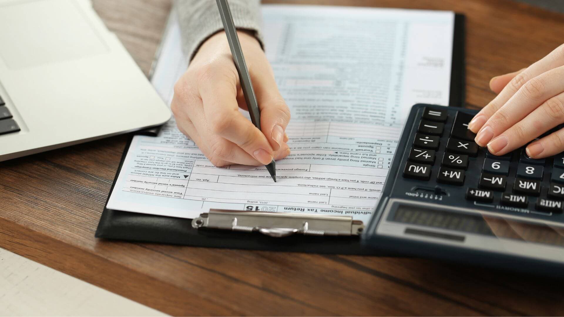 Statutory returns filing service provider at desk preparing documents